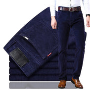 Stack of dark blue jeans with a person wearing one on a white background