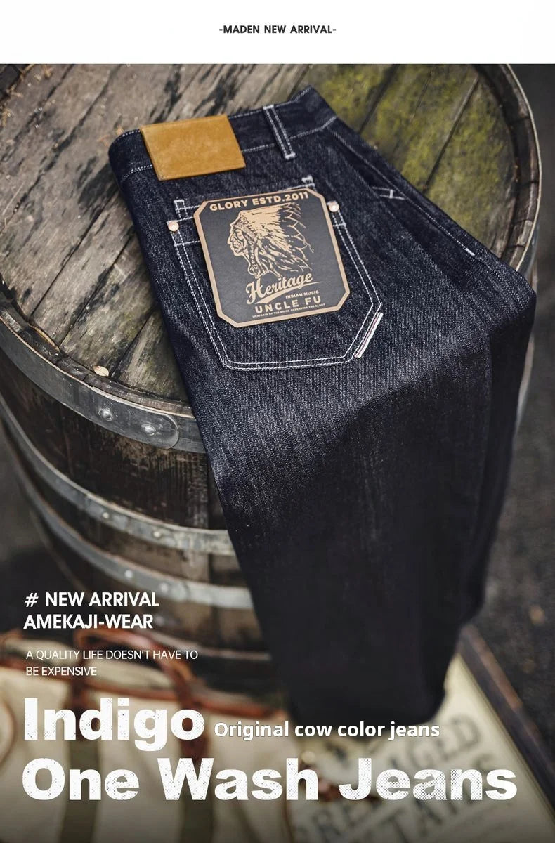 Indigo one wash jeans on a wooden barrel with branding text.