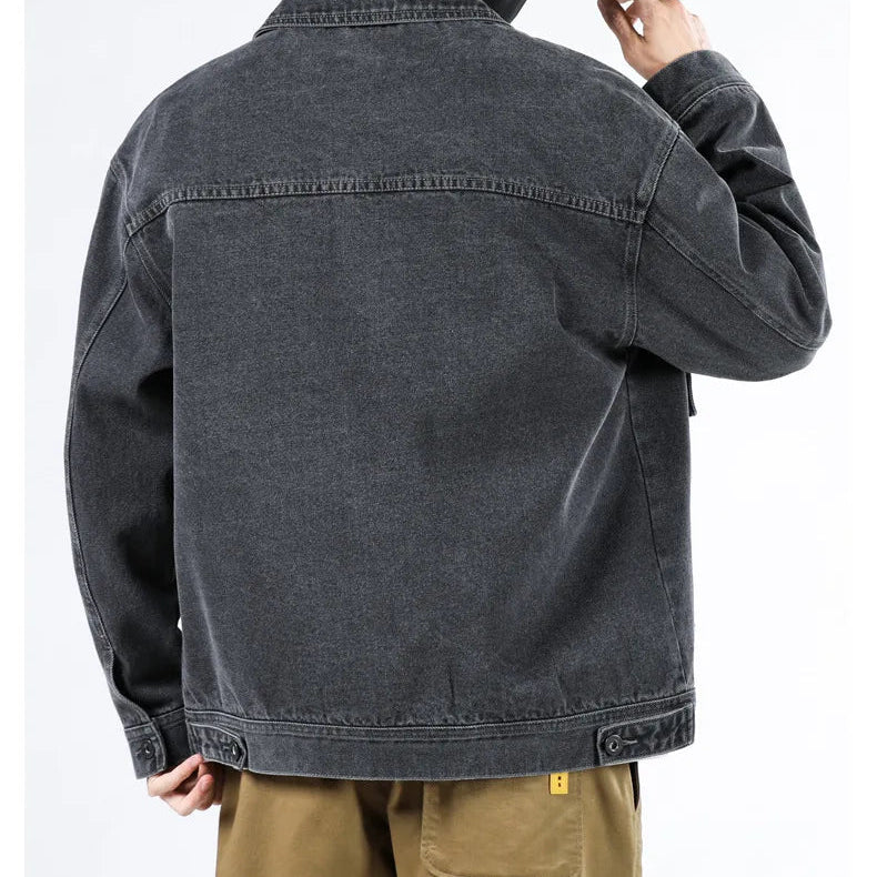 Black denim jacket worn by a person on a white background