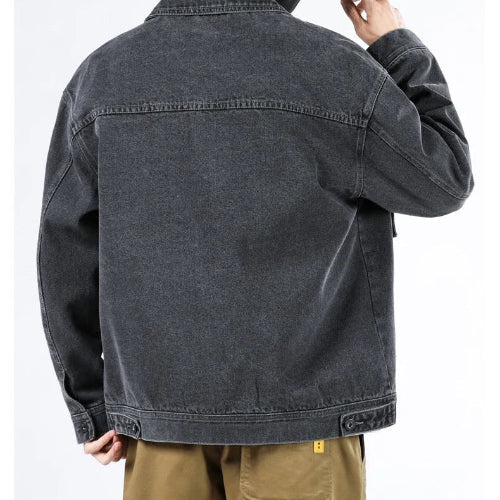 Black denim jacket worn by a person on a white background