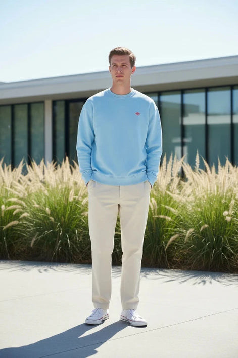 Light blue sweatshirt with a small red logo on a white background