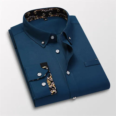 Folded blue dress shirt with decorative inner lining on a light gray background