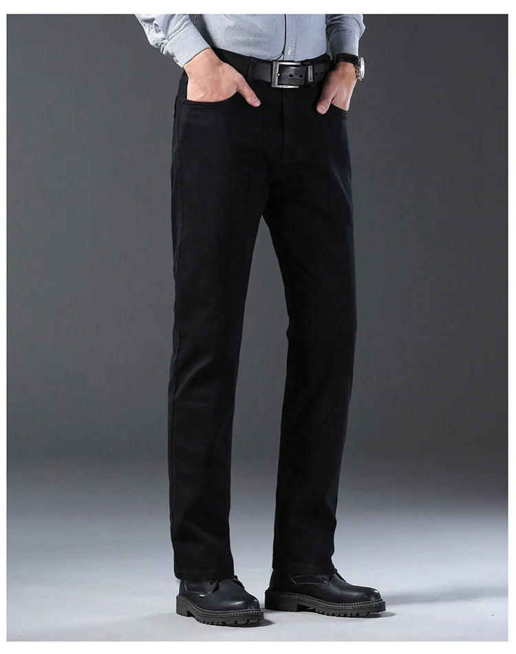 Person wearing black pants with a gray background