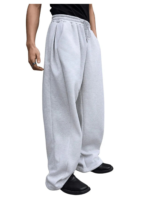 White sweatpants worn by a person on a white background