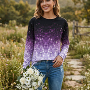 A woman wearing a long-sleeve crewneck top covered in sequins that fade from black at the top to bright 