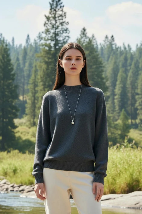 Person wearing a gray sweater with a blurred background