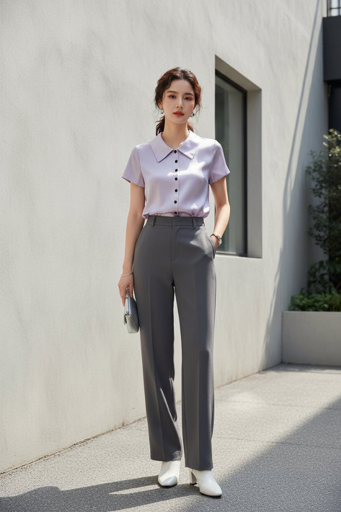 Purple satin blouse on a hanger against a neutral background