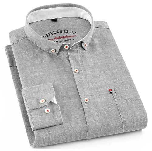 Folded gray shirt with a collar and buttons on a white background