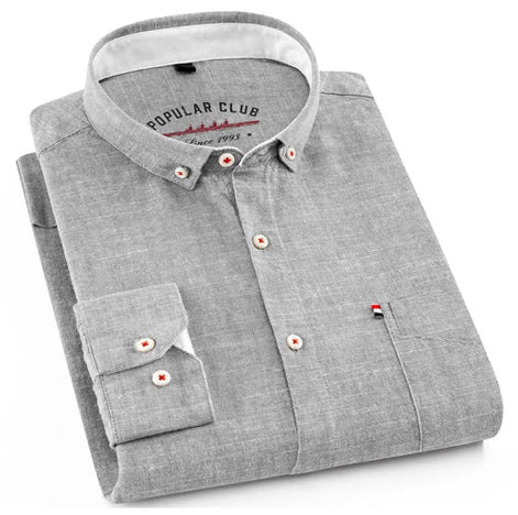 Folded gray shirt with a collar and buttons on a white background