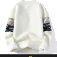 White sweater with black and gray patterned sleeves on a white background