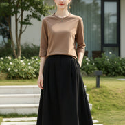 Mannequin wearing a brown long-sleeve shirt with a neutral background