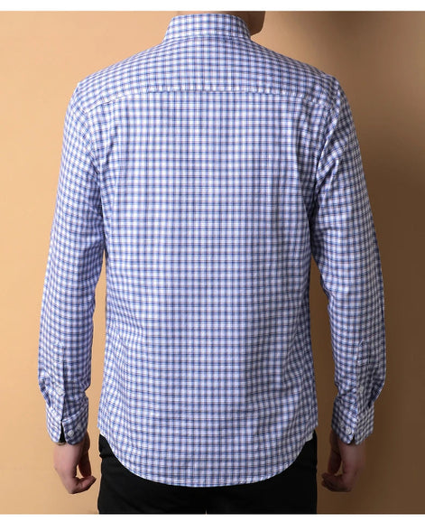 Blue and white checkered shirt worn by a person on a brown background
