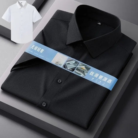 A folded black long-sleeve dress shirt with a collar and button front, wrapped in a blue promotional band, displayed on a gray geometric surface