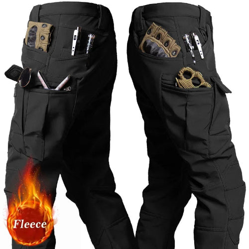 Two side views of black cargo pants showing large thigh pockets and smaller pockets holding gloves, tools, and accessories against a white background.