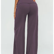 Purple wide-leg pants worn by a person on a white background