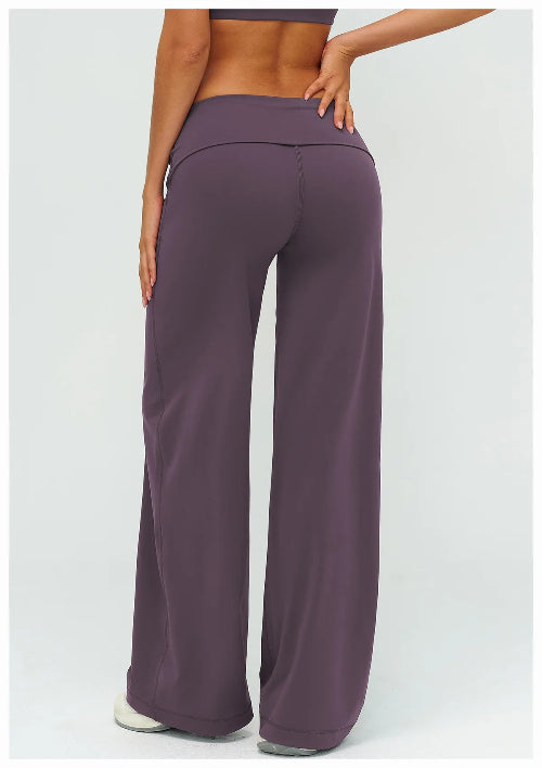 Purple wide-leg pants worn by a person on a white background