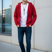 Red hoodie with a white shirt underneath on a textured gray background