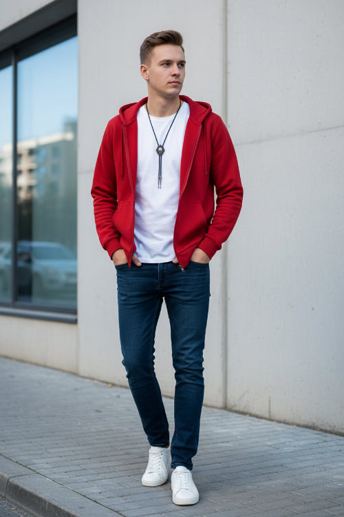 Red hoodie with a white shirt underneath on a textured gray background