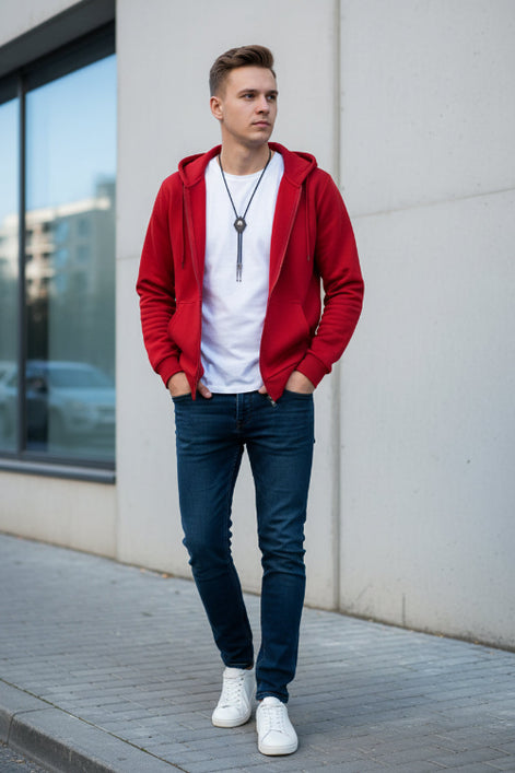 Red hoodie with a white shirt underneath on a textured gray background