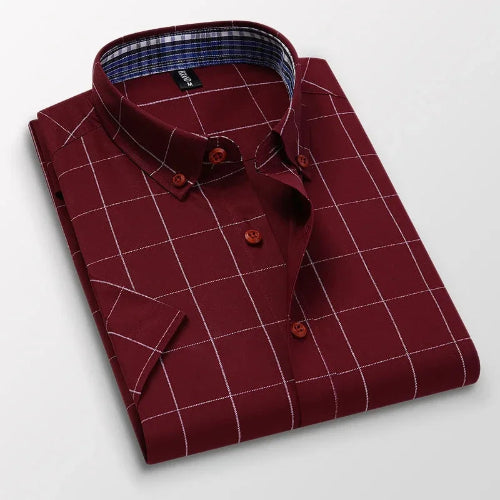 Folded maroon checkered shirt on a light gray background