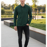 Green polo shirt with a brand logo on a hanger