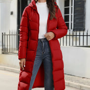 Woman wearing a red puffer coat in an urban setting