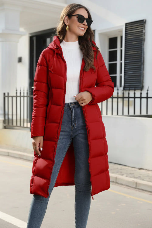 Woman wearing a red puffer coat in an urban setting