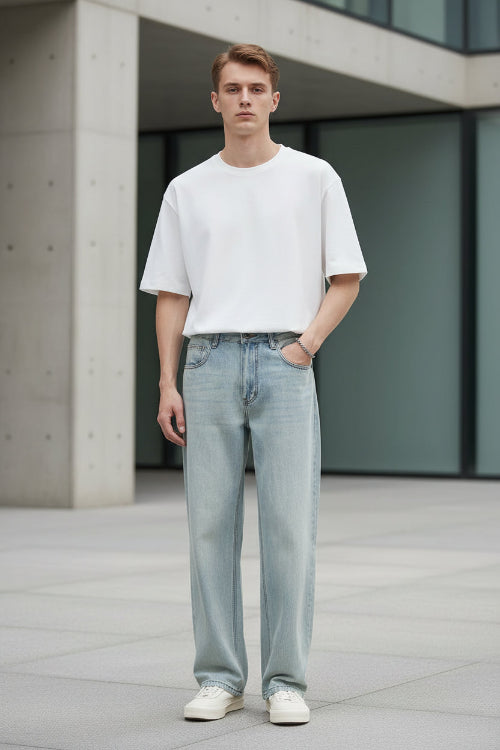 Person wearing light blue jeans and a white shirt with 'YIZHI' branding.