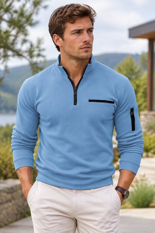 Light blue long-sleeve shirt with black zipper and pocket details on a white background