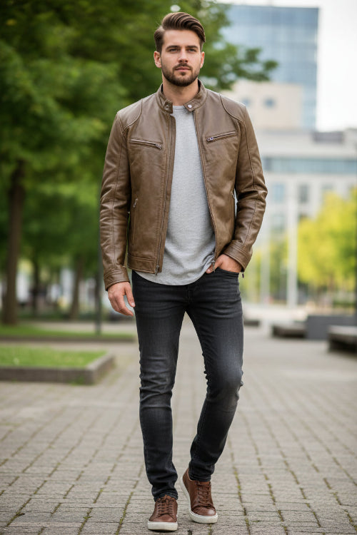 Brown leather jacket worn by a person on a white background