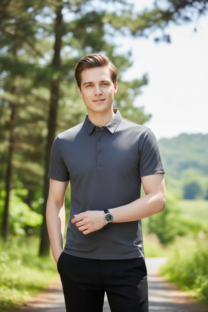 Man wearing a gray polo shirt against a gray background