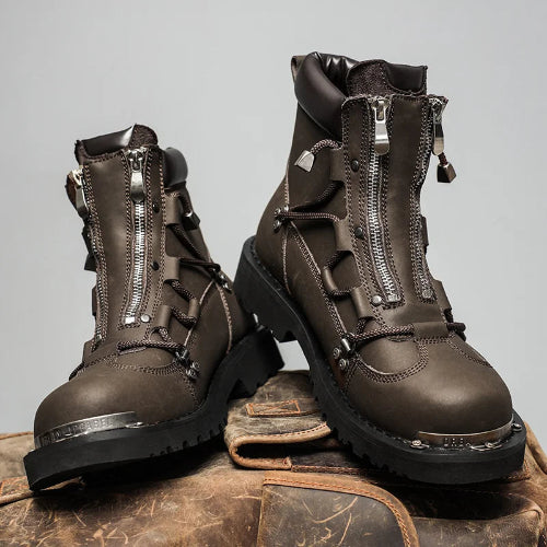 Brown leather boots with zippers on a textured surface and gray background