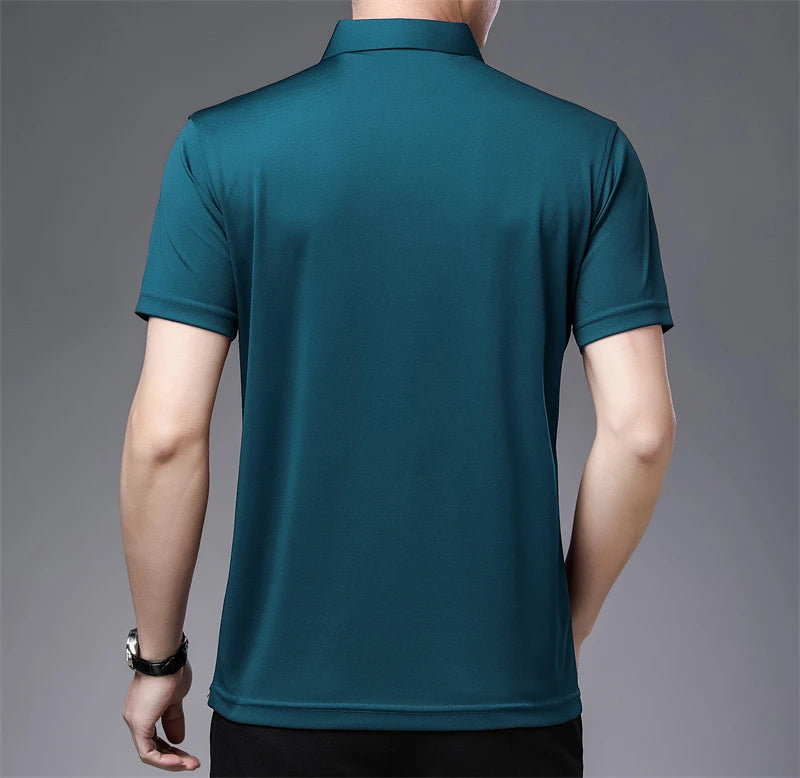 Teal polo shirt worn by a person on a gray background