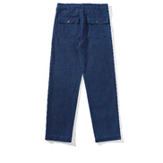 Back view of indigo sashiko fatigue pants with two buttoned flap pockets and belt loops against a white background.