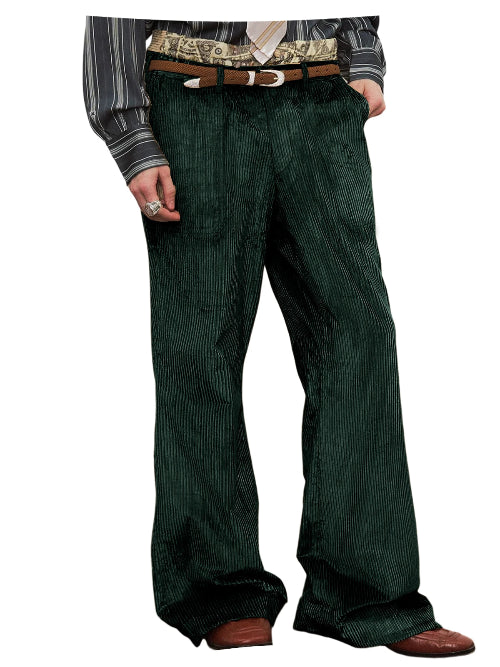A person wearing dark green corduroy trousers with a brown belt, a patterned shirt, and brown shoes, shown 