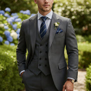 Gray suit with blue tie and pocket square on a white background