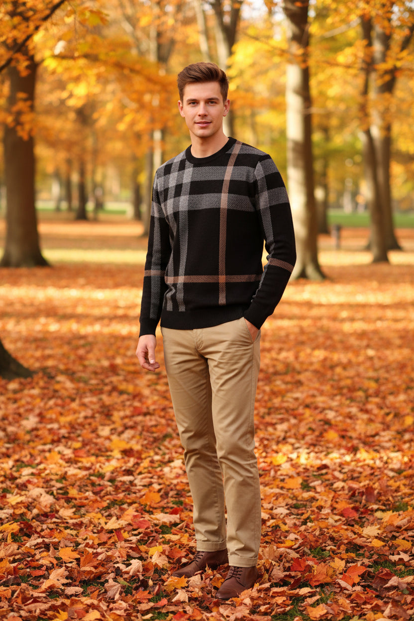 Person wearing a black and beige plaid sweater against a dark background