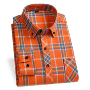 Folded orange plaid shirt on a white background