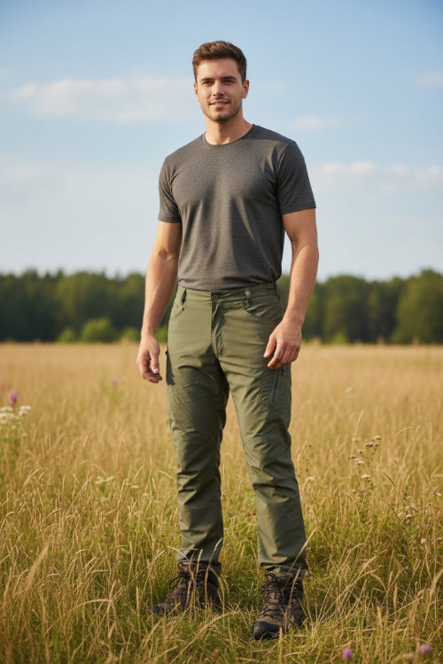 Person wearing dark gray tactical pants with multiple pockets on a white background, featuring the TacAsen brand.