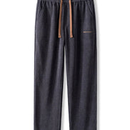 Dark gray sweatpants with a brown drawstring on a white background
