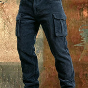 Dark blue corduroy cargo pants with a brown leather belt, shown from the waist down against a textured, rustic brown and gold background.