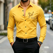 A man wearing a bright yellow long-sleeve button-up shirt with a gold horse graphic and the text 'Success at first try' on the left 