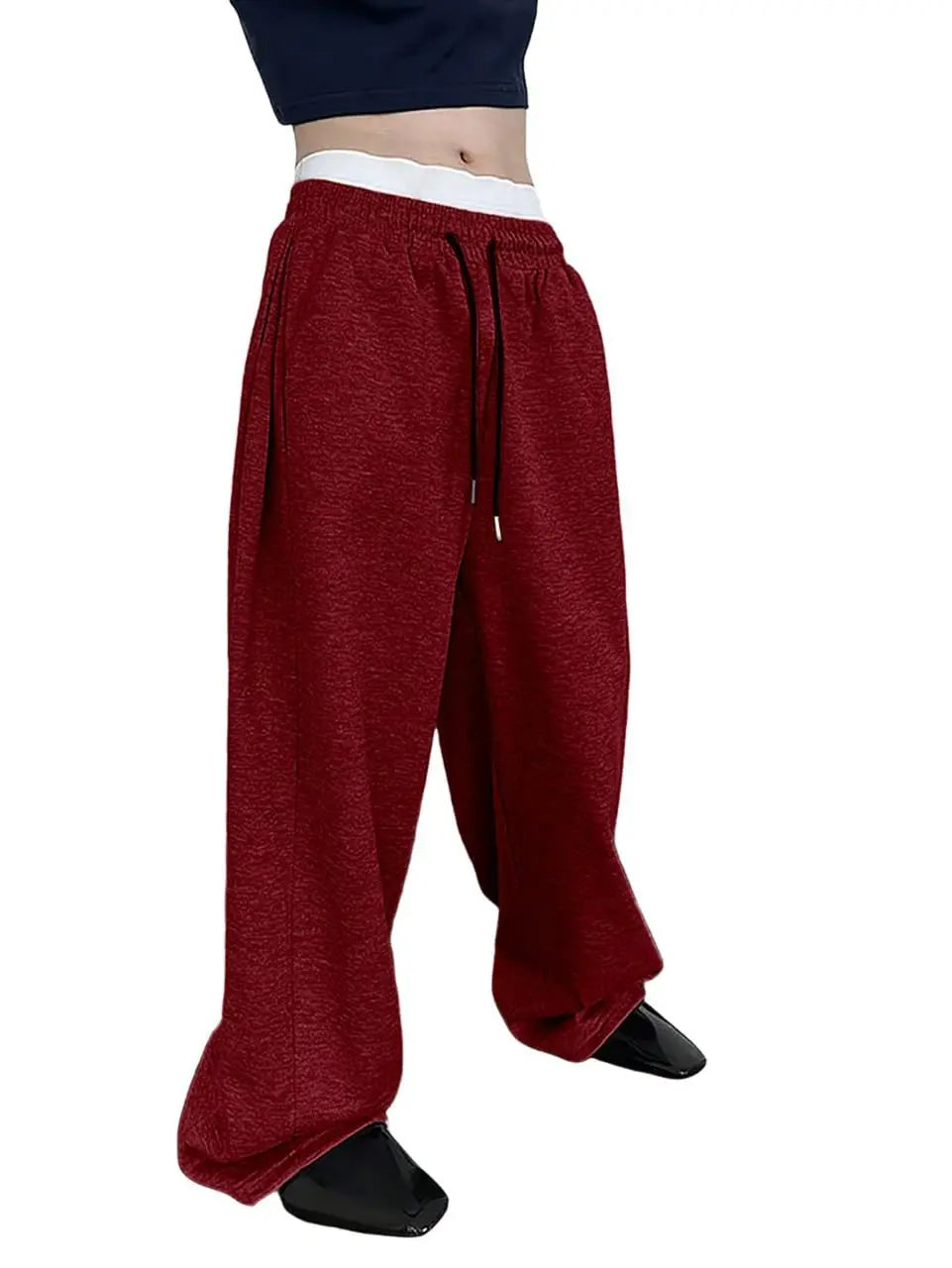 Red pants worn by a person on a white background