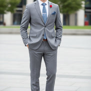 Gray suit with matching tie and shoes on a mannequin against a white background