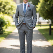 Gray suit with matching tie and shoes on a mannequin against a white background