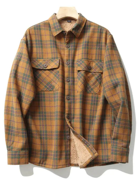 A long-sleeve plaid button-up shirt jacket in a mustard yellow, brown, and green tartan pattern, featuring a soft beige sherpa lining visible at the collar and hem, displayed on a wooden hanger against a white background.
