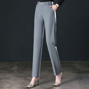 Gray pants worn by a person on a dark background