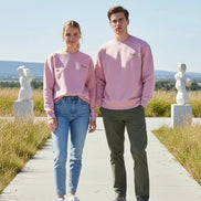 A dusty pink crewneck sweatshirt with 'Dunc' embroidered in gold on the left chest, displayed flat against a solid white background.