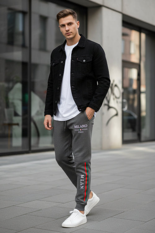Dark gray sweatpants with a white logo on a white background