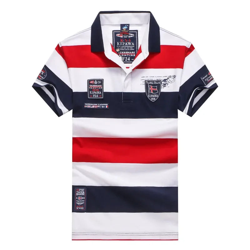 A men's short-sleeve polo shirt with horizontal stripes of navy blue, white, and red. The shirt features a navy blue collar, a two-button placket, and multiple printed patches and logos on the chest and sleeves.